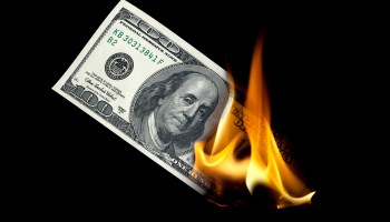 A $100 bill on fire.