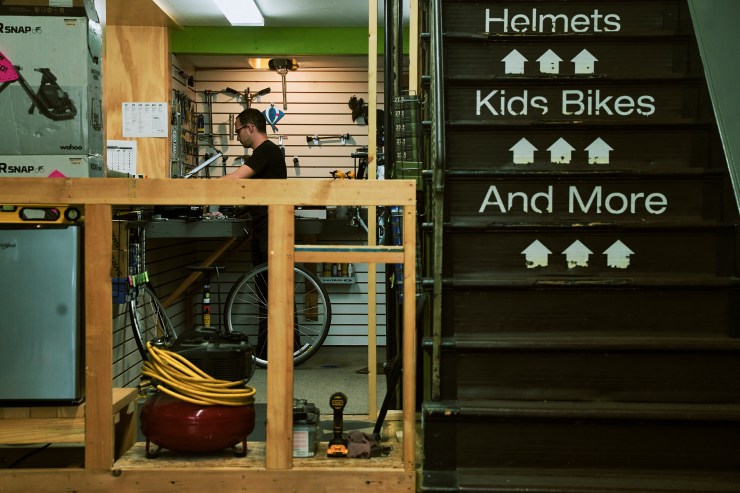 An employee works in the service section of Campus Wheelworks on Elmwood Avenue (Photo by Brandon Watson)