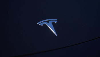 SANTA MONICA, CA - SEPTEMBER 22: A Tesla logo is seen on a vehicle in a parking lot on September 22, 2022 in Santa Monica, California. Tesla is recalling over 1 million vehicles in the U.S. because the windows can pinch a persons fingers while being rolled up. (Photo by Allison Dinner/Getty Images)