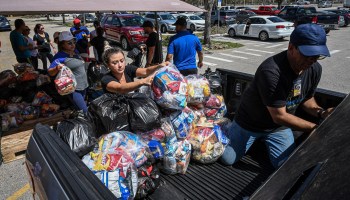 Volunteers offer free water and food to residents on San Carlos Island in Fort Myers, Florida, in the aftermath of Hurricane Ian on October 1, 2022.