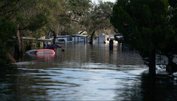 Camper trailers and vehicles are still partially submerged by floodwaters at the Peace River Campground on October 4, 2022 in Arcadia, Florida.
