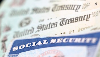 In this photo illustration, a Social Security card sits alongside checks from the U.S. Treasury.