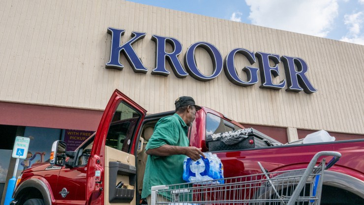 A customer loads his truck after shopping at a Kroger grocery store on Sept. 9 in Houston.
