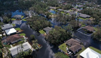 In this aerial view, a neighborhood flooded by the rising Myakka River is shown in the wake of Hurricane Ian on October 01, 2022 in North Port, Florida.