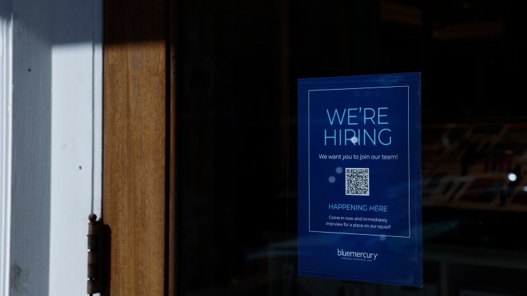 A "We're Hiring" sign is displayed in the window of a Blue Mercury Store in Georgetown in Washington, D.C.