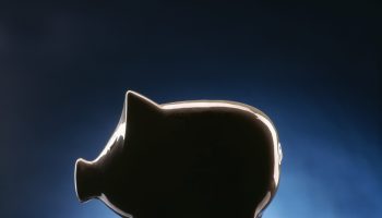 Piggy bank on dark blue black background