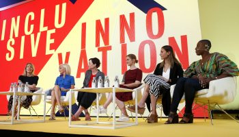 Female business leaders sit on the panel of a talk on innovation.