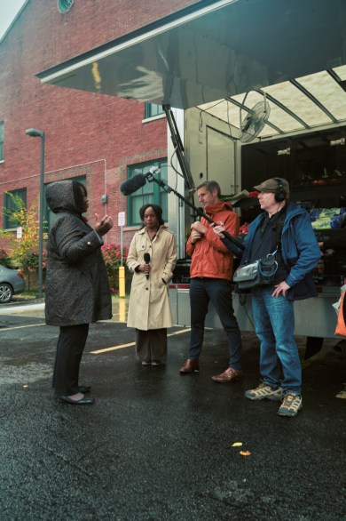 ADP chief economist Nela Richardson and Marketplace’s Kai Ryssdal talk with Chandra Redfern, CEO of the Buffalo Federation of Neighborhood Councils at a mobile produce market in east Buffalo. (Photo by Brandon Watson)