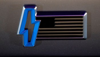 A blue lightning bolt logo on Ford's electric F-150 Lightning truck. .