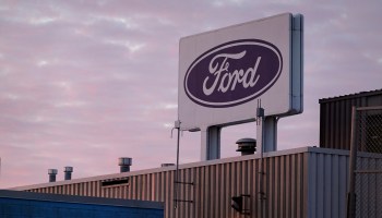 The Ford company logo on a sign above one of its plants.