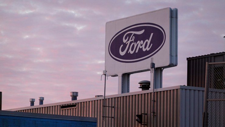 The Ford company logo on a sign above one of its plants.