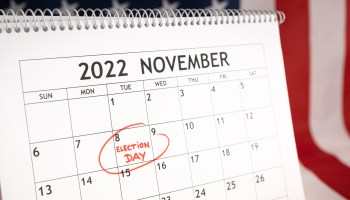 Desk calendar with November 8 2022 marked in red and USA flag at background.