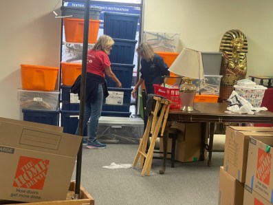 Volunteers sort through costumes and props after Hurricane Ian. Due to water and mold damage, most costumes and theatre equipment from the main building must be removed and inspected before being returned to the theatre.