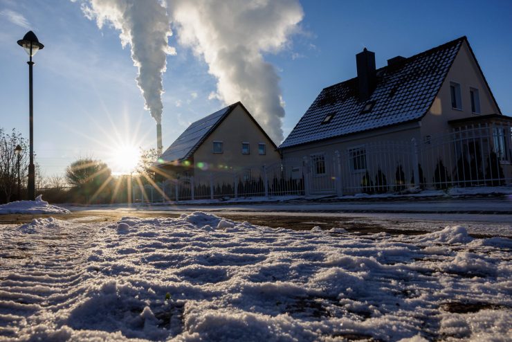 KORBETHA, GERMANY - DECEMBER 15: Snow lies in a residential area while smoke rises from the chimneys of a coal-fired power plant in the background during a sub-zero day on December 15, 2022 in Korbetha near Halle, Germany. Germany's Federal Network Agency, faced with a December that is likely to be the coldest in the past decade, is appealing to citizens to nevertheless save energy. Germany, historically dependent on natural gas imports from Russia that have fallen to near zero over recent months, has managed to at least partially compensate for the shortfalls with natural gas imports via pipelines from Norway, the Netherlands and Belgium. Germany's first LNG terminals, which will allow it to import natural gas by ship, are due to begin operation later this month. The Heizkraftwerk Mitte plant, operated by Vattenfall, supplies both heat and electricity to residences and offices in the Berlin city center. (Photo by Jens Schlueter/Getty Images)