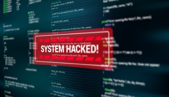 A pop-up notification in a red box reads "SYSTEM HACKED!" on a computer screen.