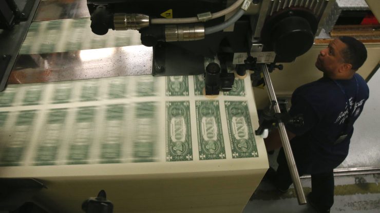 Printer Eugene Turner runs a press that is printing one dollar bills at the Bureau of Engraving and Printing on March 24, 2015 in Washington, DC.