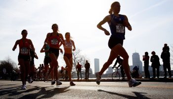Participants in the U.S. Women's Olympic Marathon Trials run on a street