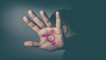 Transgender symbol painted in the palm of unrecognizable person.