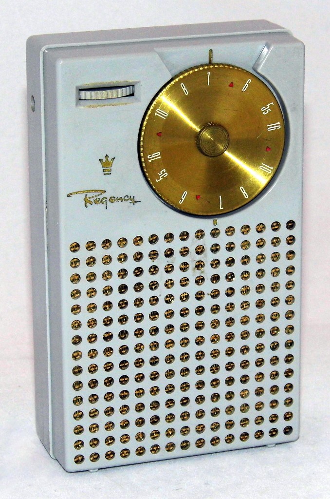 Regency TR-1 transistor radio. It is a light shade of blue with a brass dial.