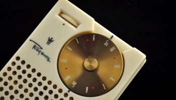 A Regency TR-1 transistor radio. You can see a dial and the speaker.