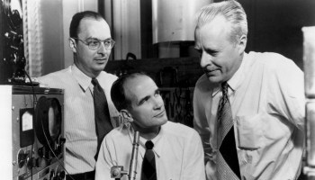 Standing, from left to right, are Bell Labs physicists John Bardeen and Walter Brattain in 1948. In the middle, sitting, is their manager, William Shockley. These three won the Nobel Prize for their work on the transistor.