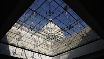 The U.S. Capitol dome seen through a glass ceiling.