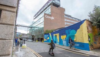 Members of the public pass the offices of Google in the business and financial sector of Dublin City centre on October 7, 2021.