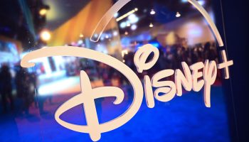 Fans are reflected in Disney+ logo during the Walt Disney D23 Expo in Anaheim, California on September 9, 2022.