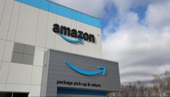 The Amazon logo is displayed on the exterior of an Amazon delivery station on November 28, 2022 in Alpharetta, Georgia.