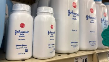Large and small containers of Johnson's baby powder lined up on a shelf in 2018.