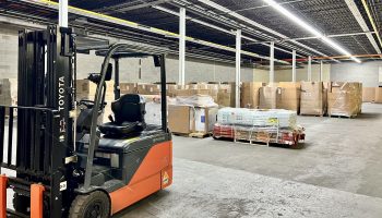 The interior of American Liquidations shows a forklift and pallets of goods.