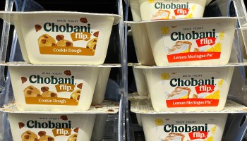 Packages of 4.5 ounce Chobani Flips, that were previously 5.3 ounces, are displayed on a shelf at Target. Some companies are using a tactic known as "sneakflation," where the product gets smaller, but the price stays the same.