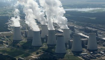 Steam rises from cooling towers at the Jaenschwalde coal-fired power plant.