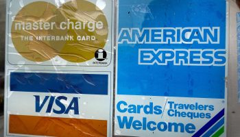 A sticker pasted at the entrance of a business lets customers know that it accepts American Express credit cards.