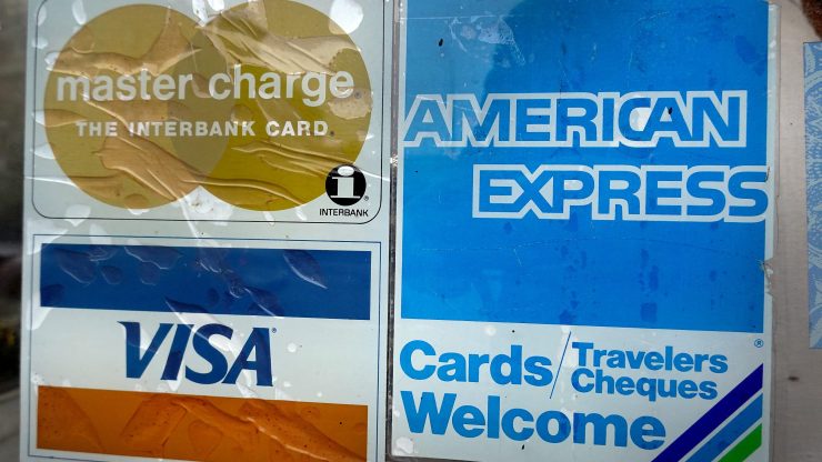 A sticker pasted at the entrance of a business lets customers know that it accepts American Express credit cards.