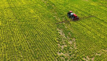 A farmer spreads pesticide on a Maryland field last spring.