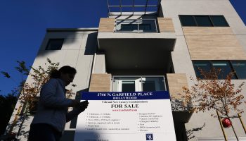 A "for sale" sign is posted in front of new condominiums for sale in December in Los Angeles.