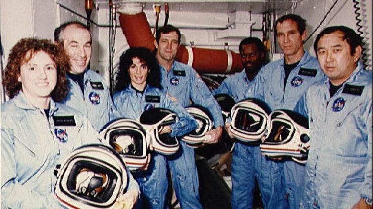 The space shuttle Challenger mission crew pose for a portrait while training at Kennedy Space Center in 1986