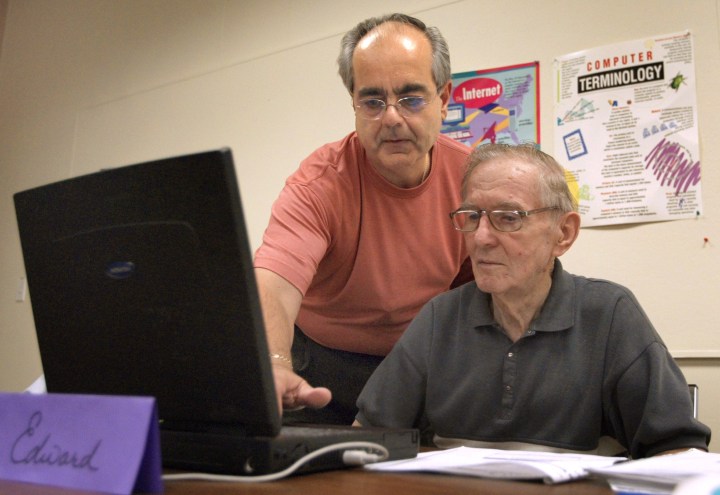 Two older men at computer