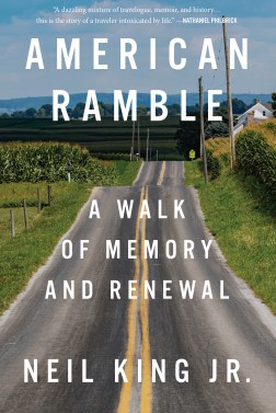 The words "American Ramble: A Walk of Memory and Renewal. Neil King Jr." are printed over a photo of a two-way road that cuts through farmland.