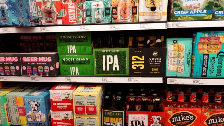 Colorful packages of craft beers and seltzer line the shelves of the store's refrigerated section.