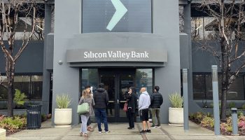 People line up outside of the shuttered Silicon Valley Bank headquarters Friday in Santa Clara, California.