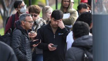 People line up outside a Silicon Valley Bank office Monday in Santa Clara, California.