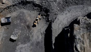 An aerial picture of trucks driving in a coal mine in Kentucky operated by Blackhawk Mining and Pine Branch Mining.