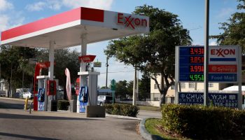 A view of an Exxon gas station with white and red gas pumps in Miami, Florida.