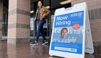 A customer walks by a now hiring sign posted in front of a Ross Dress For Less store on April 07, 2023 in Novato, California.