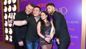 Damian Powers, Joey Sasso, Sammie Cimeralli and Mitchell Eason take a selfie in front of a Netflix and "Love is Blind" banner at Netflix’s Love Is Blind: The Live Reunion Official Watch Party at The Vermont Hollywood.