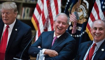 Stephen A. Schwarzman (C), CEO of the Blackstone Group, and Chris Liddell (R), White House Director of Strategic Initiatives, laugh before a meeting with US President Donald Trump (L) and others in the Eisenhower Executive Office Building on the White House campus