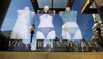 Frilly panties and bras on mannequins in a storefront window, with Victoria's Secret written across the bottom of the glass.
