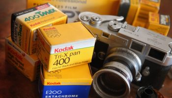 In this photo illustration, Kodak film in a yellow box is seen alongside a vintage Leica M3 35mm rangefinder camera.